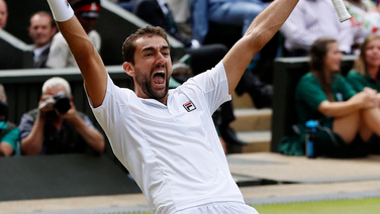 The Latest: Spectator goes on court to face Clijsters serve
